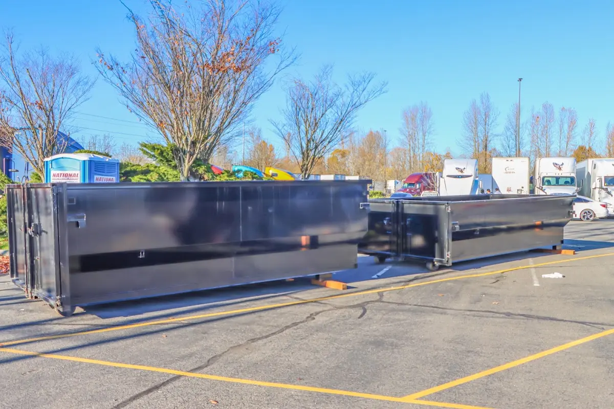 Professional dumpster rental service with roll-off container on residential driveway in Birdsboro